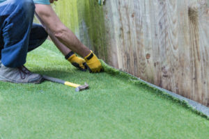 man installing synthetic grass alternative in new jersey